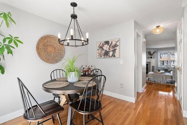 128 Parker St Unit 4C, Acton, MA 01720 - dining area with light wood-style flooring and a chandelier