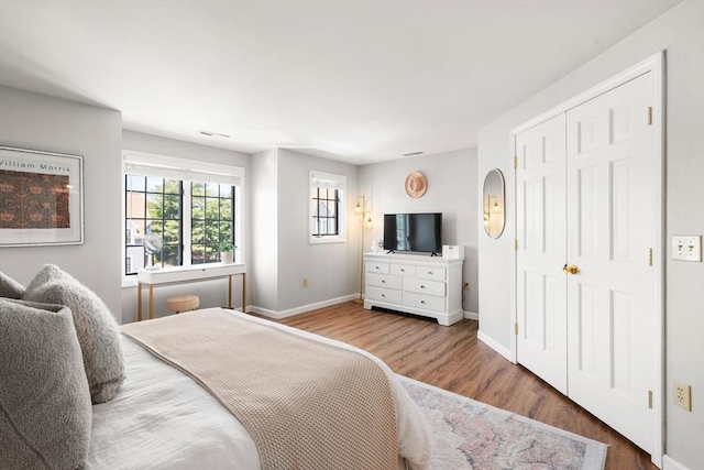 128 Parker St Unit 4C, Acton, MA 01720 - bedroom featuring wood finished floors, baseboards, and a closet