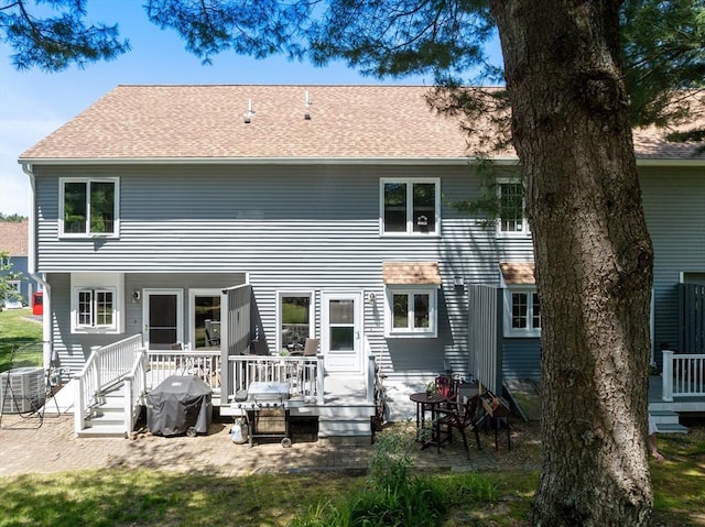 128 Parker St Unit 4C, Acton, MA 01720 - rear view of house featuring a deck and a shingled roof