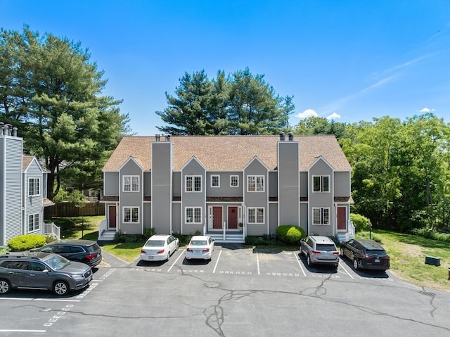 128 Parker St Unit 4C, Acton, MA 01720 - view of property with a chimney, uncovered parking, and entry steps