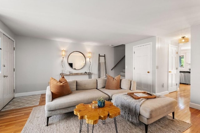 128 Parker St Unit 4C, Acton, MA 01720 - living room featuring light wood finished floors, baseboards, and stairway