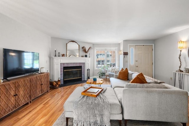 128 Parker St Unit 4C, Acton, MA 01720 - living room with light wood finished floors and a brick fireplace