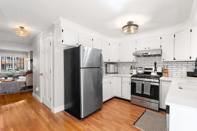 128 Parker St Unit 4C, Acton, MA 01720 - kitchen featuring appliances with stainless steel finishes, under cabinet range hood, light countertops, and backsplash