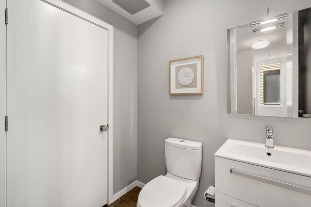 525 E 1st St Unit 5, Boston, MA 02127 - bathroom featuring toilet, vanity, wood finished floors, and baseboards