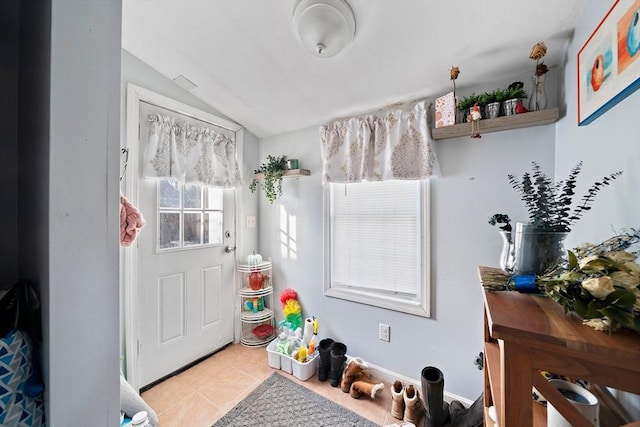 playroom featuring lofted ceiling and light tile patterned flooring