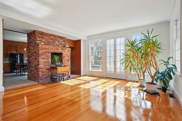 157 Washington St, Duxbury, MA 02332 - unfurnished living room with french doors, crown molding, wood finished floors, and visible vents