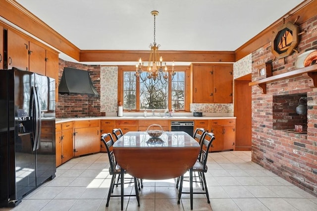157 Washington St, Duxbury, MA 02332 - kitchen featuring an inviting chandelier, brick wall, light countertops, black appliances, and ventilation hood