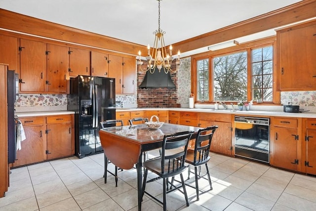 157 Washington St, Duxbury, MA 02332 - kitchen featuring an inviting chandelier, light countertops, black fridge with ice dispenser, brown cabinets, and dishwashing machine