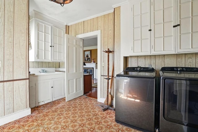 157 Washington St, Duxbury, MA 02332 - laundry area with a sink, ornamental molding, independent washer and dryer, cabinet space, and wood walls