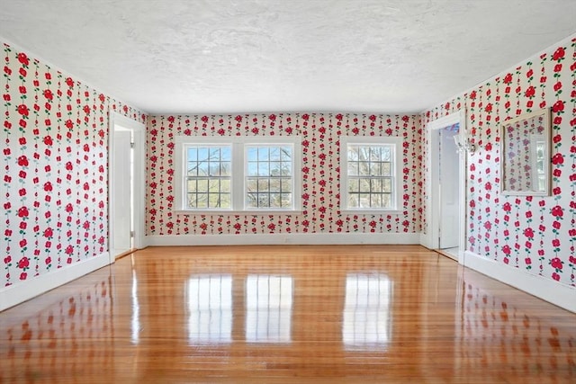 157 Washington St, Duxbury, MA 02332 - unfurnished room featuring a wealth of natural light, a textured ceiling, baseboards, and wallpapered walls