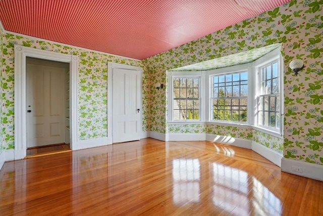 157 Washington St, Duxbury, MA 02332 - empty room featuring baseboards, wood finished floors, and wallpapered walls