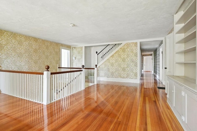 157 Washington St, Duxbury, MA 02332 - spare room featuring light wood-type flooring, wallpapered walls, and a textured ceiling