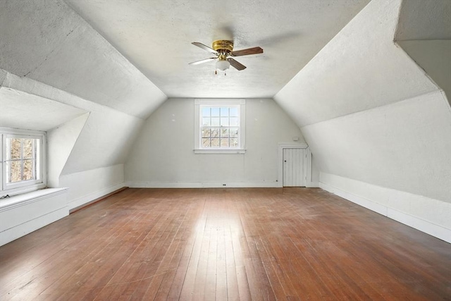 157 Washington St, Duxbury, MA 02332 - bonus room with a ceiling fan, hardwood / wood-style floors, vaulted ceiling, and a textured ceiling