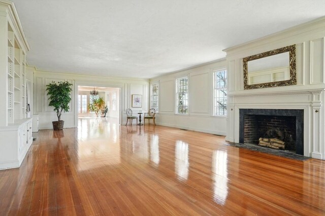 157 Washington St, Duxbury, MA 02332 - unfurnished living room with a decorative wall, hardwood / wood-style floors, and a healthy amount of sunlight