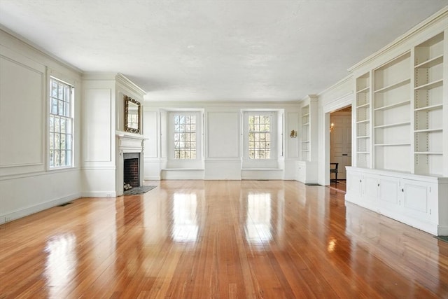 157 Washington St, Duxbury, MA 02332 - unfurnished living room featuring a decorative wall, light wood finished floors, and built in shelves