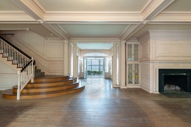 40 Prince St, Beverly, MA 01915 - entryway with ornate columns, ornamental molding, stairs, dark wood-style floors, and a fireplace with flush hearth