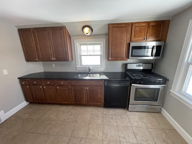 kitchen featuring sink, light tile patterned floors, and appliances with stainless steel finishes