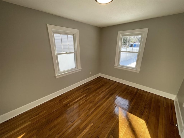 unfurnished room with wood-type flooring