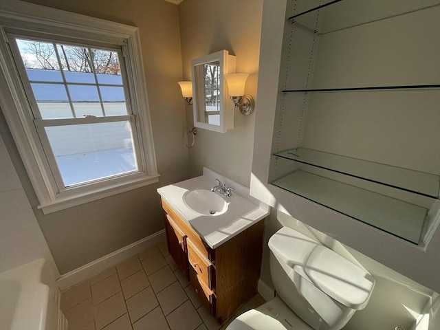 bathroom with vanity, a washtub, tile patterned floors, and toilet