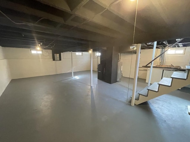 basement with a wealth of natural light and electric panel