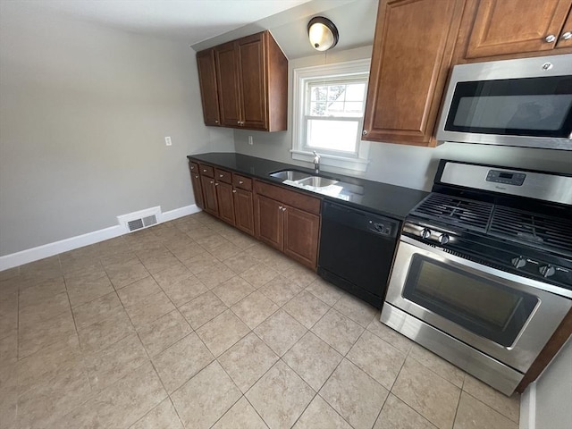 kitchen featuring appliances with stainless steel finishes, sink, and light tile patterned floors