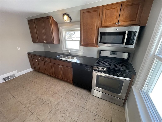 kitchen with sink, light tile patterned floors, and stainless steel appliances