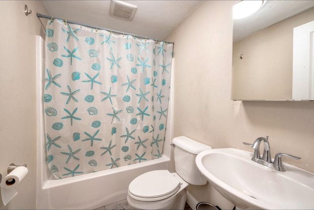 full bathroom featuring toilet, sink, and shower / bath combo with shower curtain