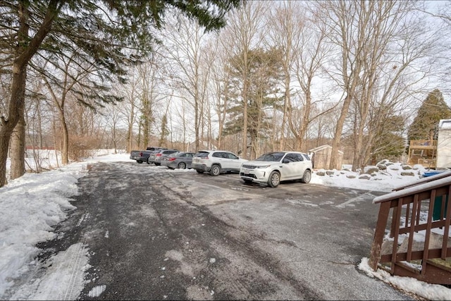 view of snow covered parking area