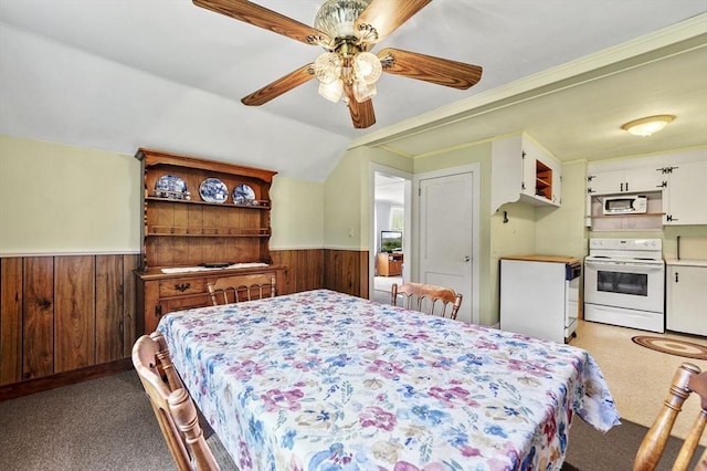18 Stover Ct, Amesbury, MA 01913 - carpeted bedroom with a wainscoted wall, wood walls, lofted ceiling, and ceiling fan