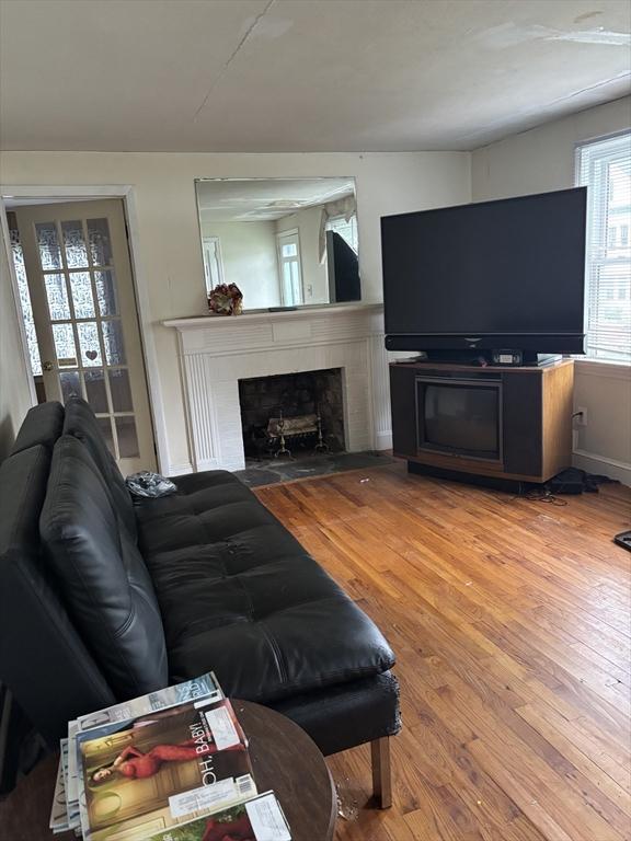 113 Lexington St, Springfield, MA 01107 - living area featuring a fireplace with flush hearth and wood finished floors
