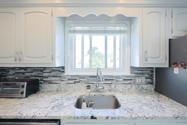 40 Atwood St, Revere, MA 02151 - kitchen featuring white cabinetry, backsplash, and light stone counters