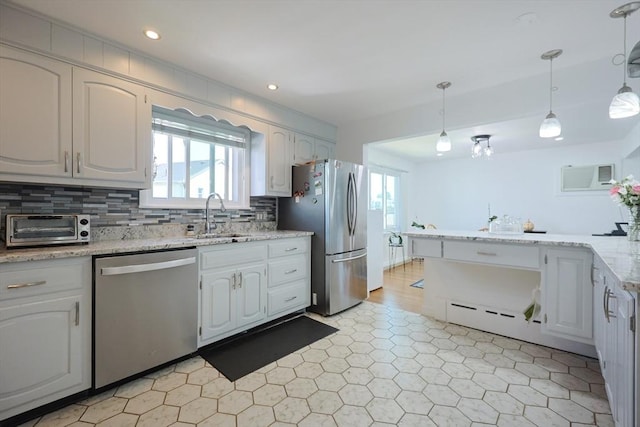 40 Atwood St, Revere, MA 02151 - kitchen with stainless steel appliances, healthy amount of natural light, tasteful backsplash, an AC wall unit, and recessed lighting