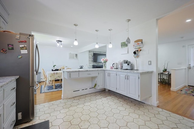 40 Atwood St, Revere, MA 02151 - kitchen featuring freestanding refrigerator, a baseboard radiator, white cabinetry, a peninsula, and decorative light fixtures