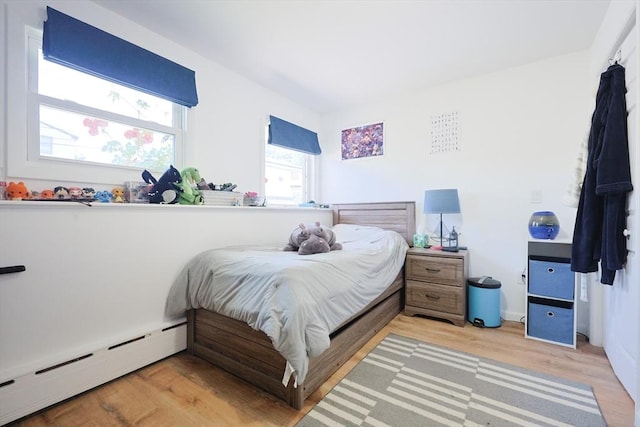 40 Atwood St, Revere, MA 02151 - bedroom featuring a baseboard heating unit and light wood-style floors