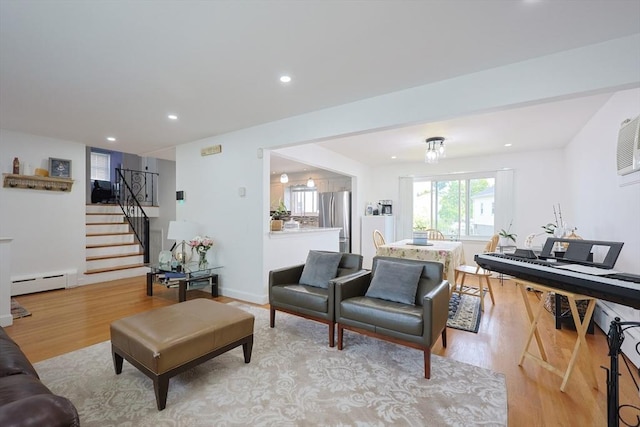 40 Atwood St, Revere, MA 02151 - living room featuring a baseboard heating unit, light wood-style flooring, stairs, and recessed lighting