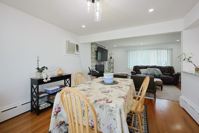 40 Atwood St, Revere, MA 02151 - dining area with a baseboard heating unit, light wood finished floors, a fireplace, a wall mounted air conditioner, and recessed lighting
