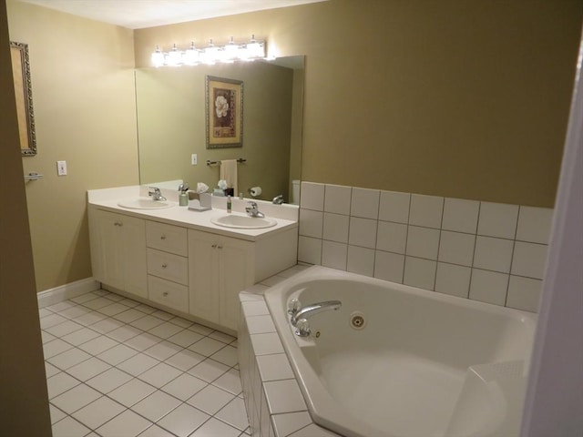 bathroom with a relaxing tiled tub, tile patterned floors, and vanity