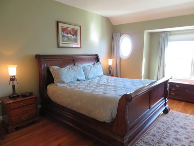 bedroom featuring lofted ceiling and light hardwood / wood-style flooring