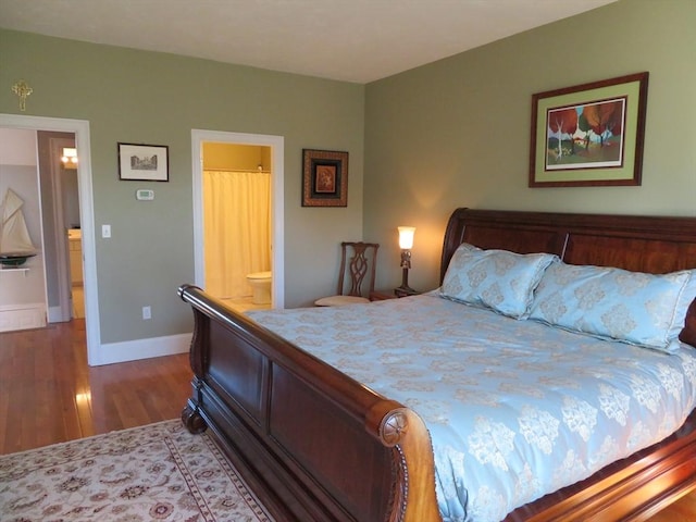 bedroom featuring ensuite bath and hardwood / wood-style flooring