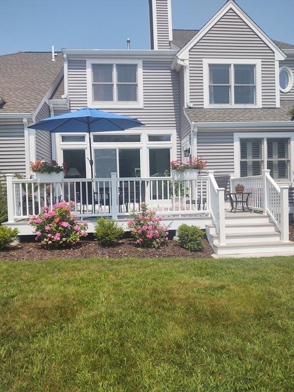 back of house with a yard and covered porch