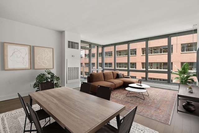1 Charles St S Unit 604, Boston, MA 02116 - dining space with hardwood / wood-style flooring, a wall of windows, and baseboards