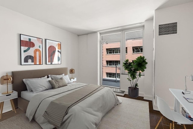 1 Charles St S Unit 604, Boston, MA 02116 - bedroom featuring multiple windows, dark wood-type flooring, and baseboards