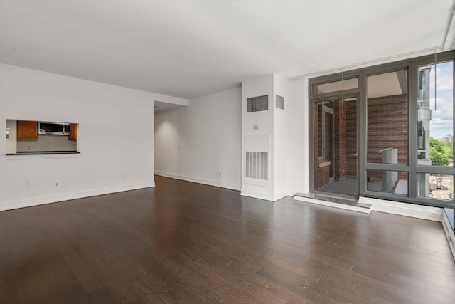 1 Charles St S Unit 604, Boston, MA 02116 - unfurnished living room featuring wood finished floors, baseboards, and expansive windows
