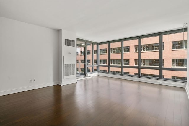 1 Charles St S Unit 604, Boston, MA 02116 - empty room featuring wood finished floors, baseboards, and floor to ceiling windows