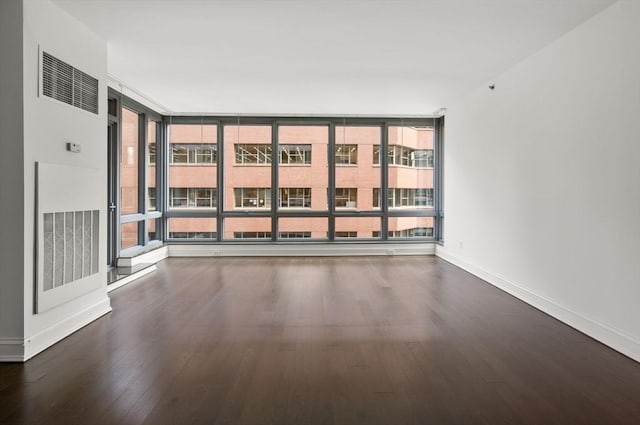 1 Charles St S Unit 604, Boston, MA 02116 - unfurnished room with wood finished floors, baseboards, and a wall of windows