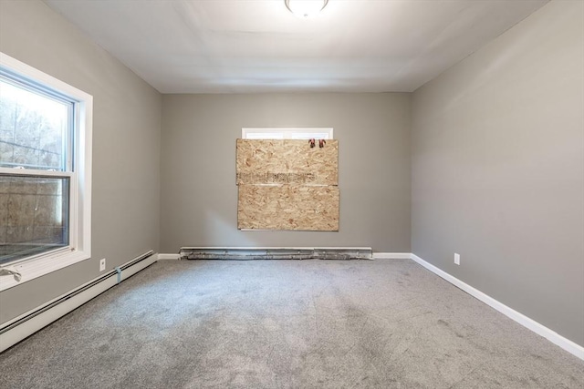 carpeted spare room featuring baseboards, a healthy amount of sunlight, and baseboard heating