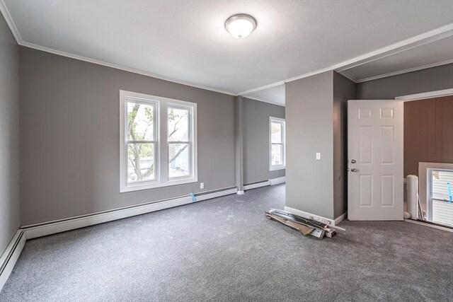 carpeted spare room featuring crown molding, baseboards, and a baseboard radiator