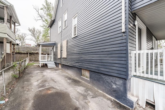 view of side of property with a patio area and fence