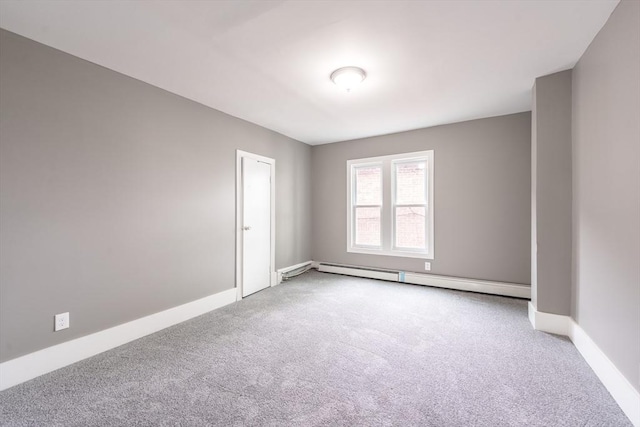 carpeted empty room with baseboards and a baseboard heating unit