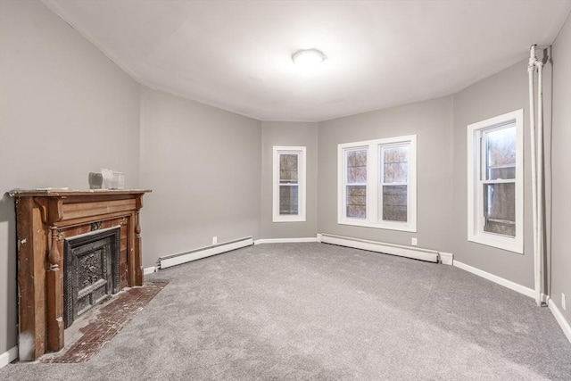 unfurnished living room with carpet, a fireplace with flush hearth, and a baseboard heating unit